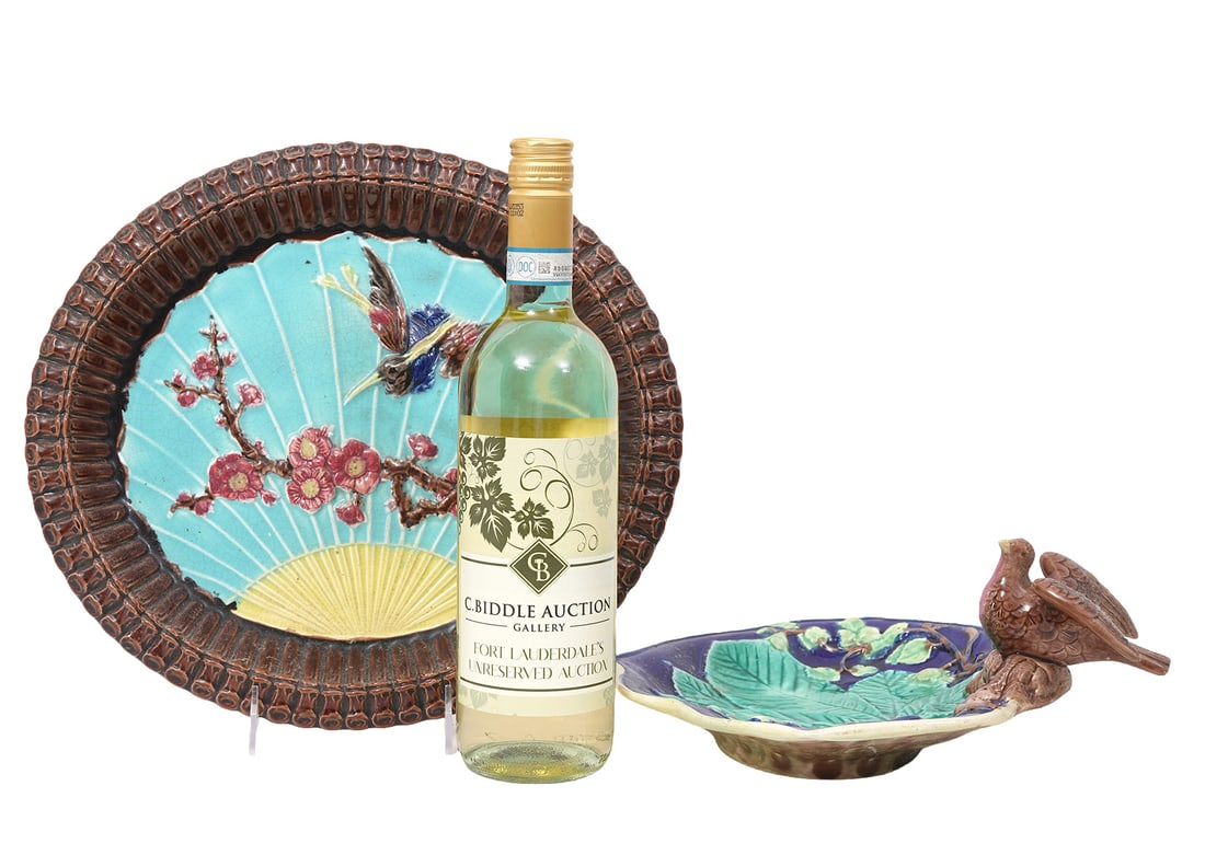 Two Avian-Themed Majolica Pottery Dishes: Two avian-themed Majolica pottery dishes includes Basket-style dish with raised decoration in center (12.5"L x 11.5"W); Leaf-form with cultural bird figure (10"L x 11"W). Condition report: Good condit