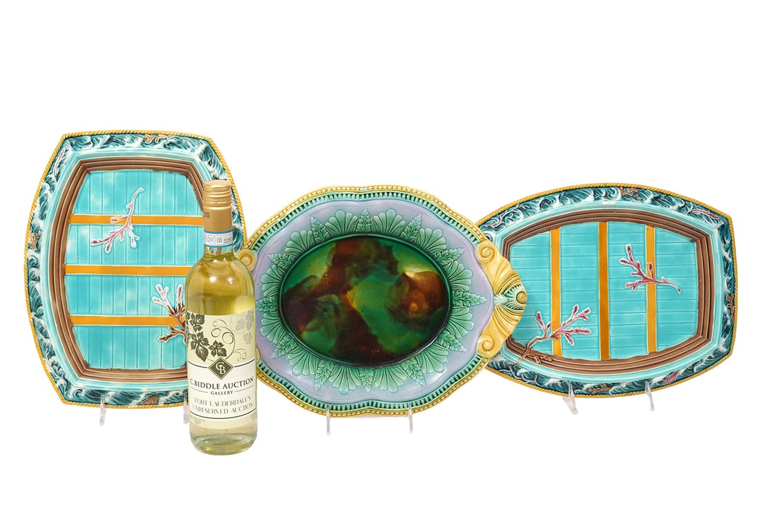 Three Large Majolica Pottery Platters: Three large Majolica pottery platters includes two Wedgwood nautical-style platters (13"H x 10"W) and a Flora-motif dish unmarked. Measures 14"H x 10.5"W. Condition report: Good condition, please exam
