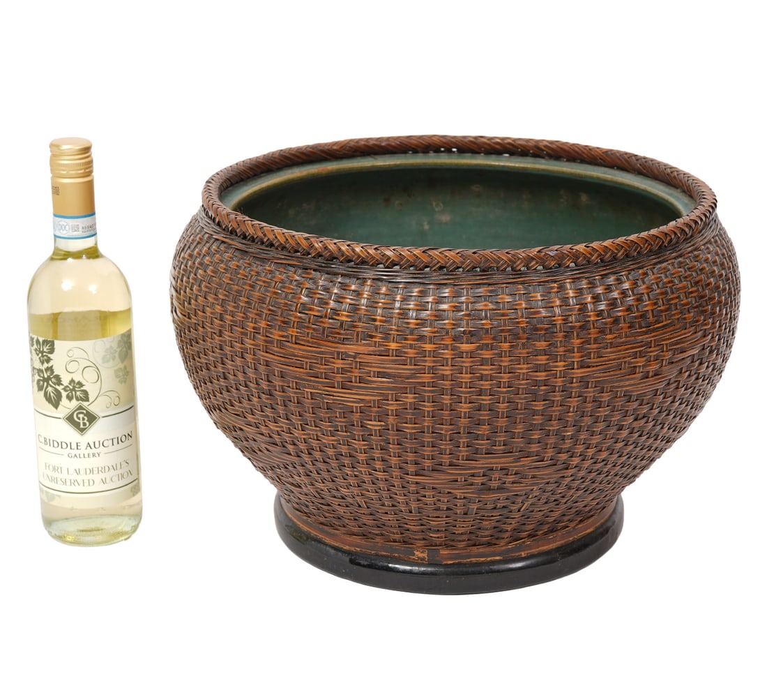 Japanese Artisanal Hand-Woven Basket Planter: Japanese artisanal hand-woven bamboo basket with ceramic planter. Measures 16.5"H x 10.5"W. Condition report: Good condition, please examine all photos closely. Contact C. Biddle Auction Gallery for m