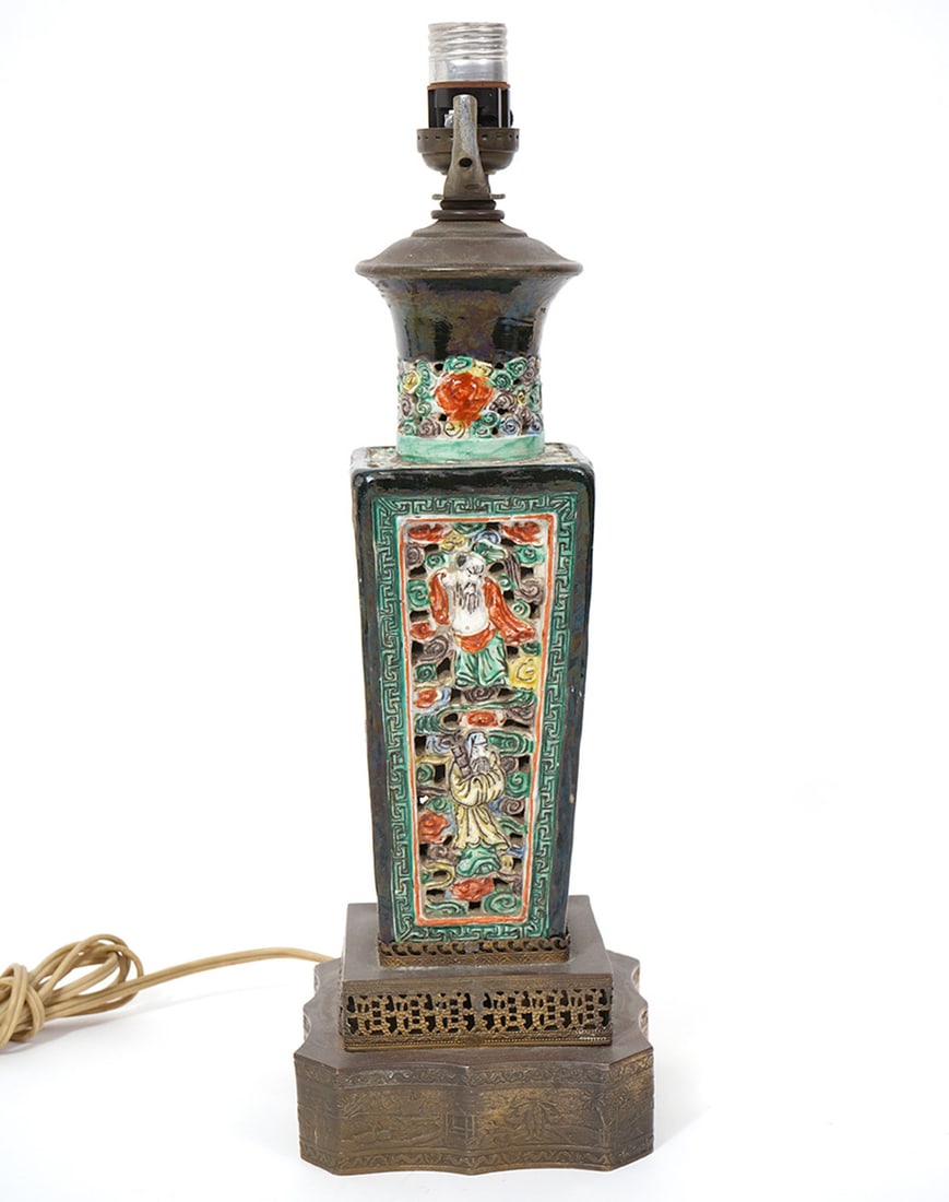 Vintage Chinese Famille Noire Lamp: Vintage Chinese famille noire square table lamp has a single socket and features enameled reticulated figures mounted on tiered square formed pierced metal base. Measures 15.25"H to top of socket; 5"L