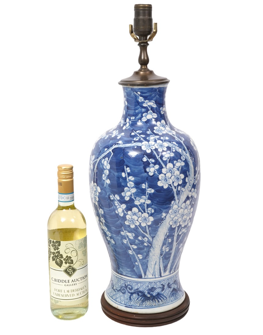 Chinese Blue Cherry Blossom Table Lamp: Chinese Blue Cherry Blossom Table Lamp decorated overall in Prunus pattern of white cherry blossoms against blue background. Lamp has a single socket and is mounted on a circular wood base. Measures 2