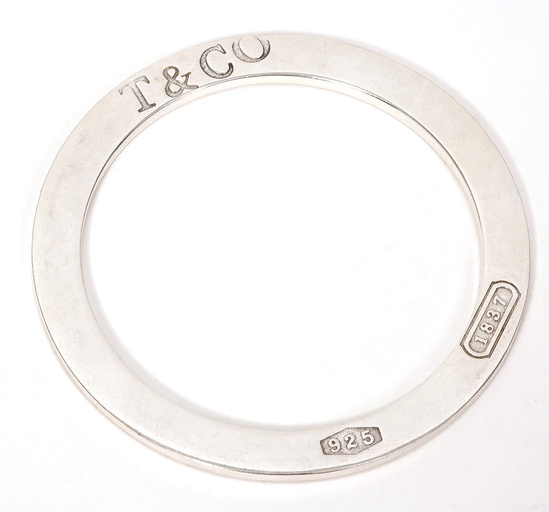 Tiffany & Co Sterling Silver Flat Bangle: Tiffany & Co sterling silver flat bangle has stamped hallmarks on edge. Measures 6cm inner circumference. Weight - 36.5g. Condition report: Good condition, please examine all photos closely. Contact C