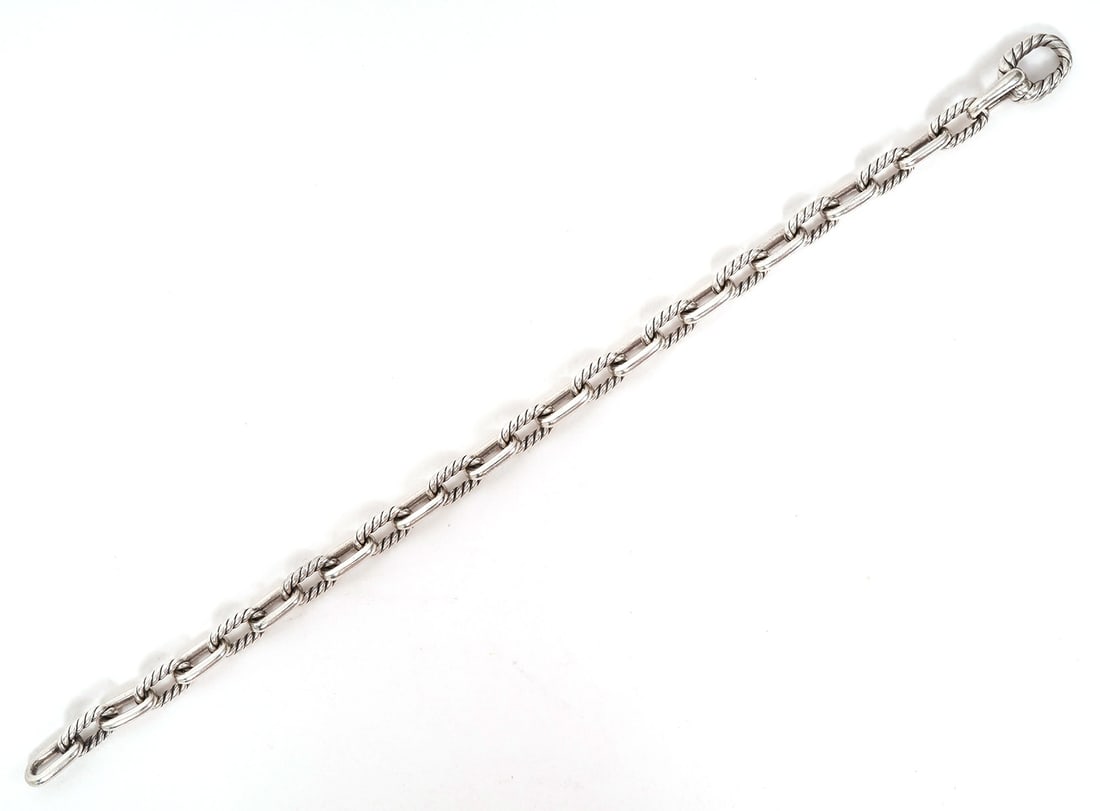 David Yurman Sterling Silver Chain-Style Bracelet: David Yurman sterling silver bracelet features alternating style chains. Measures 7.25" long. Weight - 14.4g. Condition report: Good condition, please examine all photos closely. Contact C. Biddle Auc