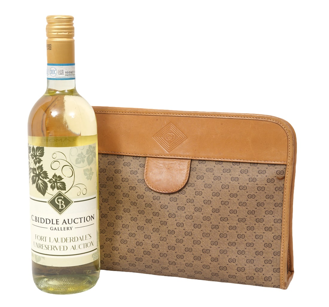 Gucci Tan Leather GG Monogram Cosmetic Bag: Gucci tan leather GG monogram canvas cosmetic bag with pull tab to open. Measures 7.5"H x 10.5"W. Condition report: Common wear from use, please examine all photos closely. Contact C. Biddle Auction G