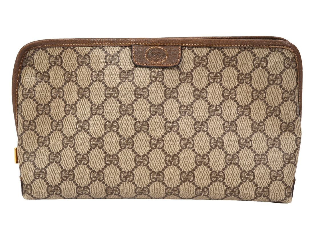 Gucci GG Monogram Canvas Cosmetic Bag: Gucci GG monogram canvas zippered cosmetic bag. Measure 7"H x 11"W. Condition report: Common wear from use, please examine all photos closely. Contact C. Biddle Auction Gallery for more detailed infor