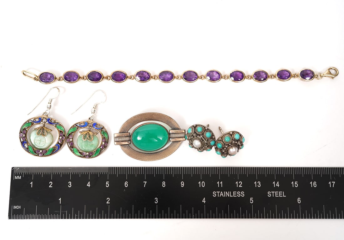 Silver Jewelry Lot Earrings, Pin, Bracelet: Silver and amethyst-color stone bracelet (6.5"L), Sterling & 12K deco-style pin (1.5"), Chinese enamel on silver earrings (1"), Silver with turqouise and pearl stud earring (0.75"). Condition report: 