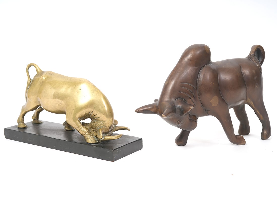 Two Bronze Bull Figures: Two bronze bull figures include a Chinese bronze bull on black slate base (8"L x 2.75"W x 4.75"H), signed underside and a brown patinated bronze bull (8.5"L x 3"W x 5.75"H). Condition report: Good