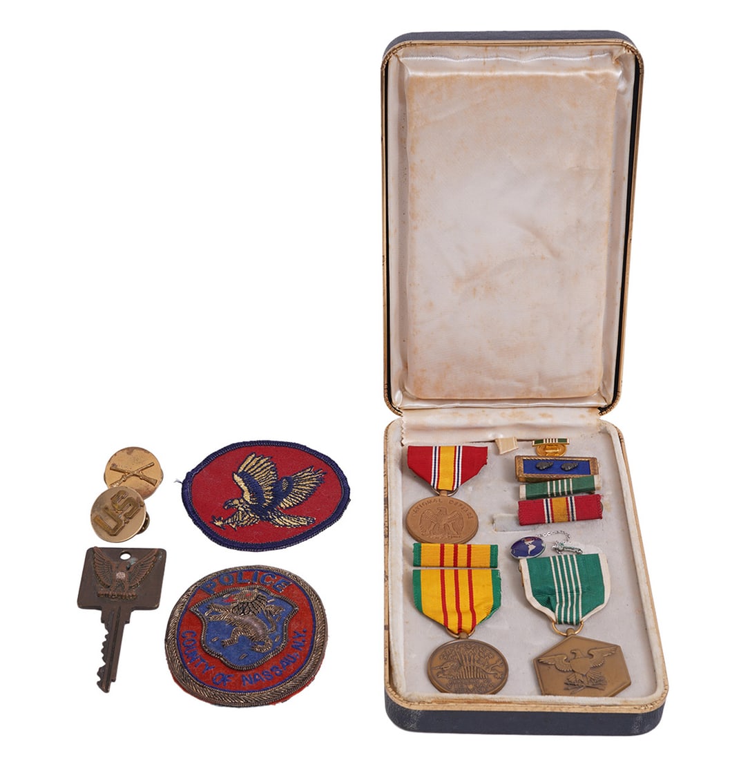 Collection of Militaria Badges and Patches: Collection of Militaria badges, bronze medals and patches including a 'County of Nassau Police' patch, grouped in case. Condition report: Good condition, please examine all photos closely. Contact C. 