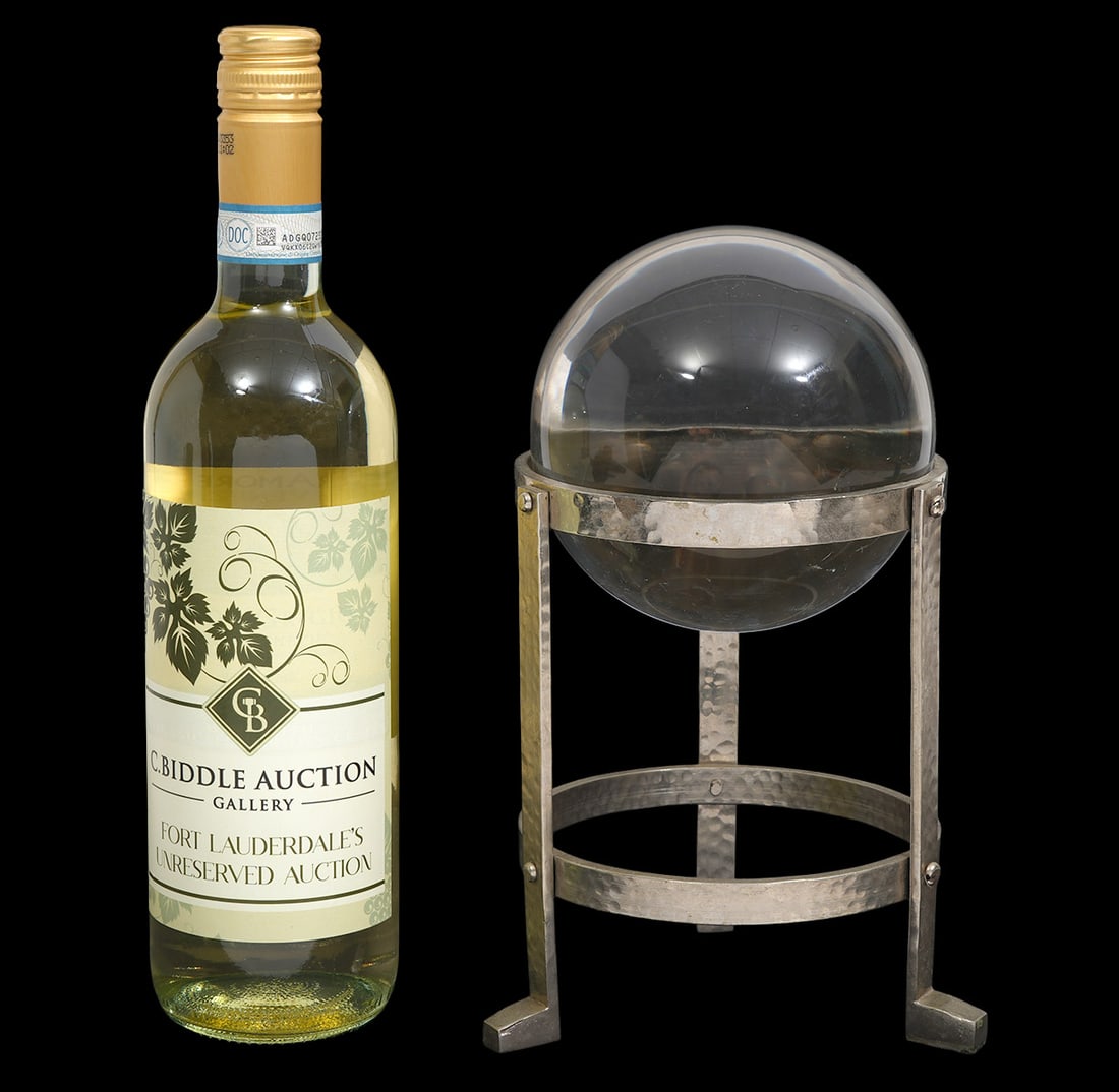 Crystal Ball in a Silver-Tone Metal Tripod Stand: Crystal ball in a hammered-finished silver-tone metal tripod stand. Sphere measures approx 4.75" diameter. Overall 9.5"H. Condition report: Minor scruff/scratches, please examine all photos closely. C