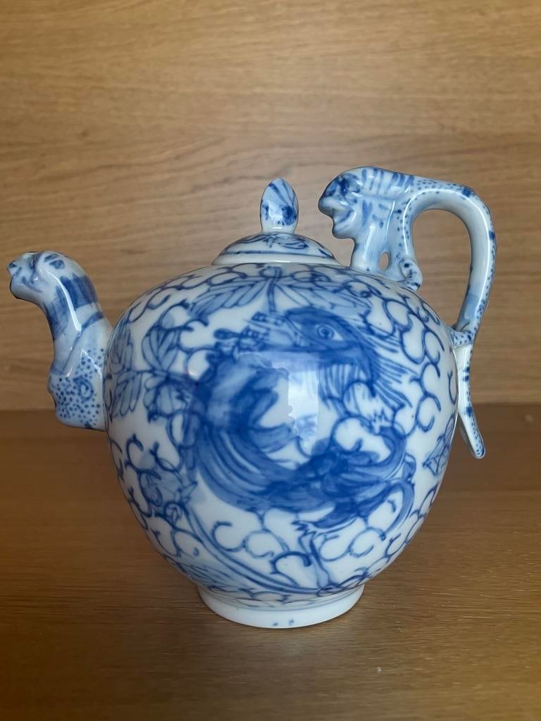 Vintage Oriental Blue and White Teapot Novelty Decorative Ornamental Ceramic Teapot Round Chinese Dr: fabulous collectible blue and white teapot with large flying dragon pattern and figural embellished spout and handle....... Usable teapot with all over cloud and dragon design, signed on the base, and