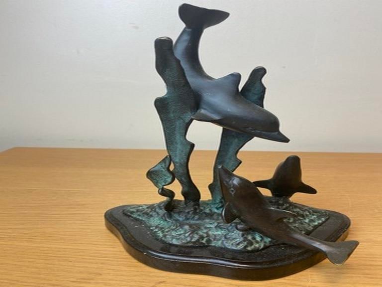 A vintage bronze sculpture depicting dolphins leaping from the water, 20th century. (1 of 6)