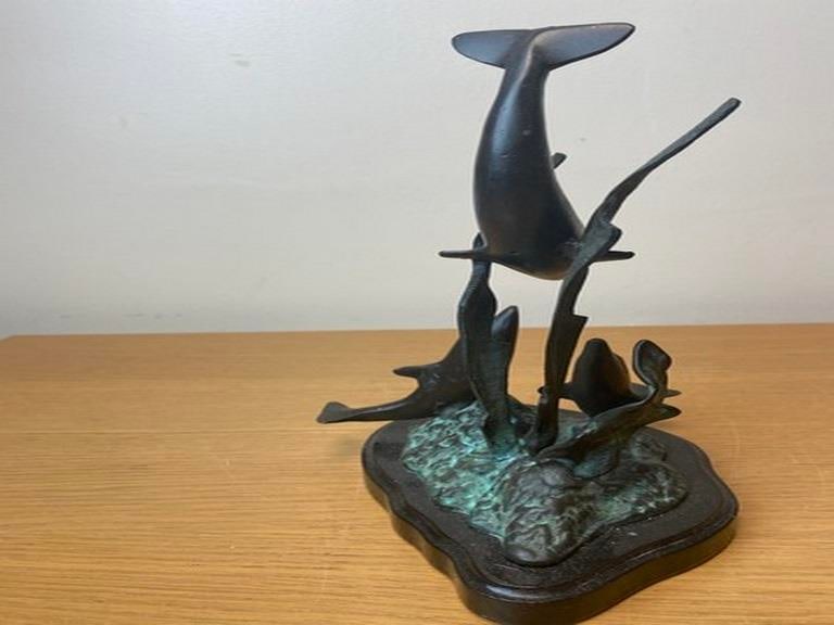 A vintage bronze sculpture depicting dolphins leaping from the water, 20th century. - 2