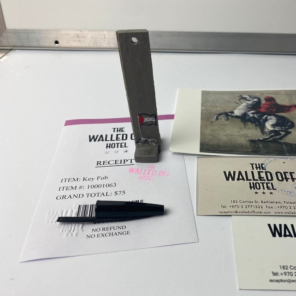 BANKSY- THE WALLED OFF HOTEL KEY FOB -: BANKSY- THE WALLED OFF HOTEL KEY FOB - 2022 New Edition Key Ring Sculpture.The Walled Off Hotel Hand painted. Hand made key fob sculpture. 1 x key Panel Size- 8.8 x 7.7 x 3.1cm Limited edition of 100T