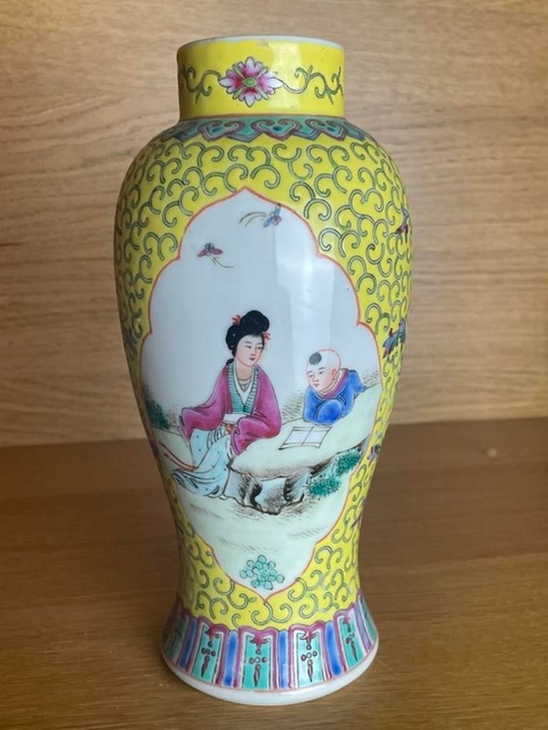 Chinese yellow famille rose vase: Chinese tall jar and Famille rose hand painted with makers mark to base Chinese republic period No cracks or chips Good for age and looks impressive on display Shows figures, bats and flowers Stands 1