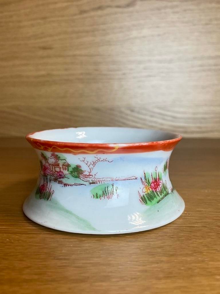 A Chinese famille rose bowl 19th century, of circular form with everted rim and shallow circular bas: 19th century, of circular form with everted rim and shallow circular base, decorated in well painted enamels with figures and poems, above a band of peonies, prunus and gourds, similar floral and