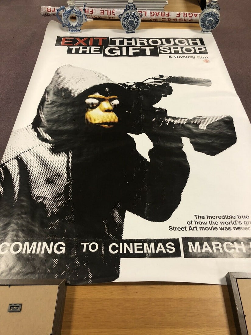 BANKSY- EXIT THROUGH THE GIFT SHOP OFFICIAL CINEMA POSTER 2010: This poster was gifted by the artist Banksy at the local cinema when Banksy€™s EXIT THROUGH THE GIFT SHOP film was on viewing at cinema.It was displayed in the display case outside the fro