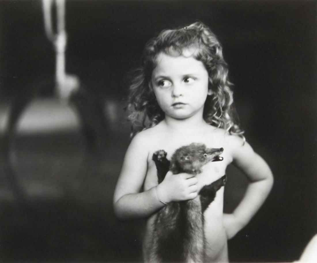 Sally Mann, Holding the Weasel, 1989: Photographer: Sally Mann is an American photographer, widely known for her large-format, black-and-white photographs at first of her young children, then later of landscapes suggesting decay and death