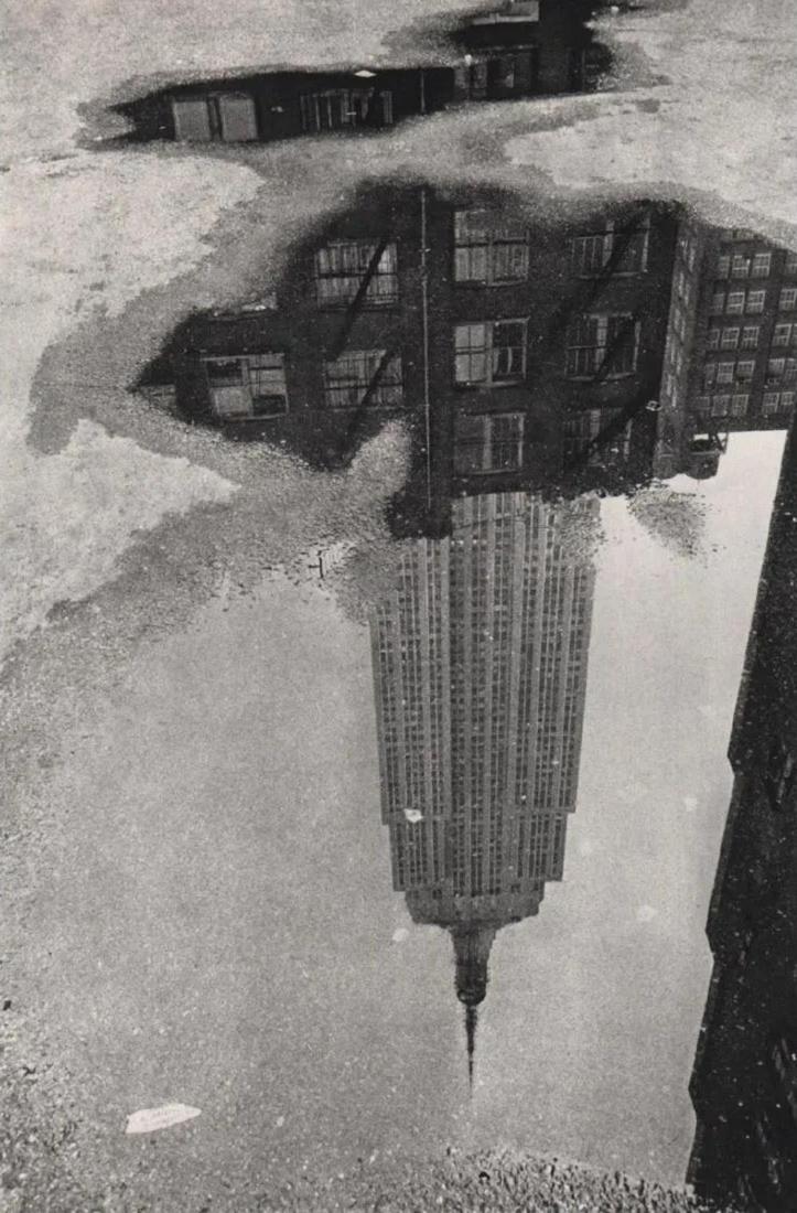 ANDRE KERTESZ - Puddle, New York, 1967: Photographer: Andre Kertesz, born Andor Kertesz, was a Hungarian-born photographer known for his groundbreaking contributions to photographic composition and the photo essay. In the early years of his