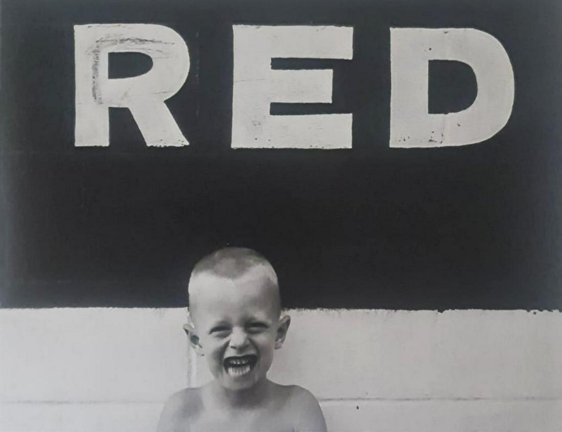 Ralph Eugene, Boy with sign, Red 1955: Photographer: Ralph Eugene Meatyard (May 15, 1925 ? May 7, 1972) was an American photographer from Normal, Illinois, U.S. Meatyard purchased his first camera in 1950 to photograph his newborn first ch