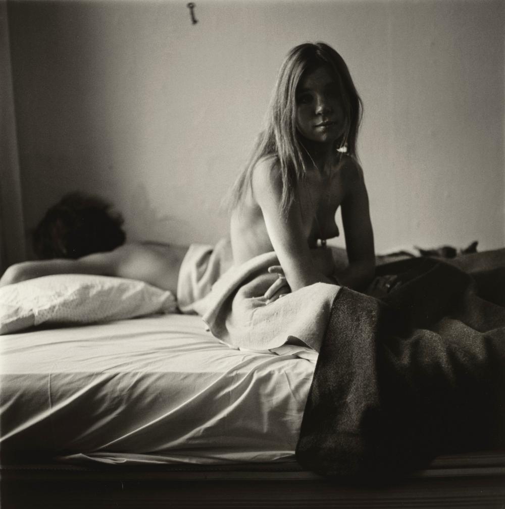Diane Arbus, Girl sitting in bad with her boyfriend, NYC, 1966: Photographer: Diane Arbus )1923 -1971) was an American photographer. Arbus worked to normalize marginalized groups and highlight the importance of proper representation of all people. Title: Girl sitt
