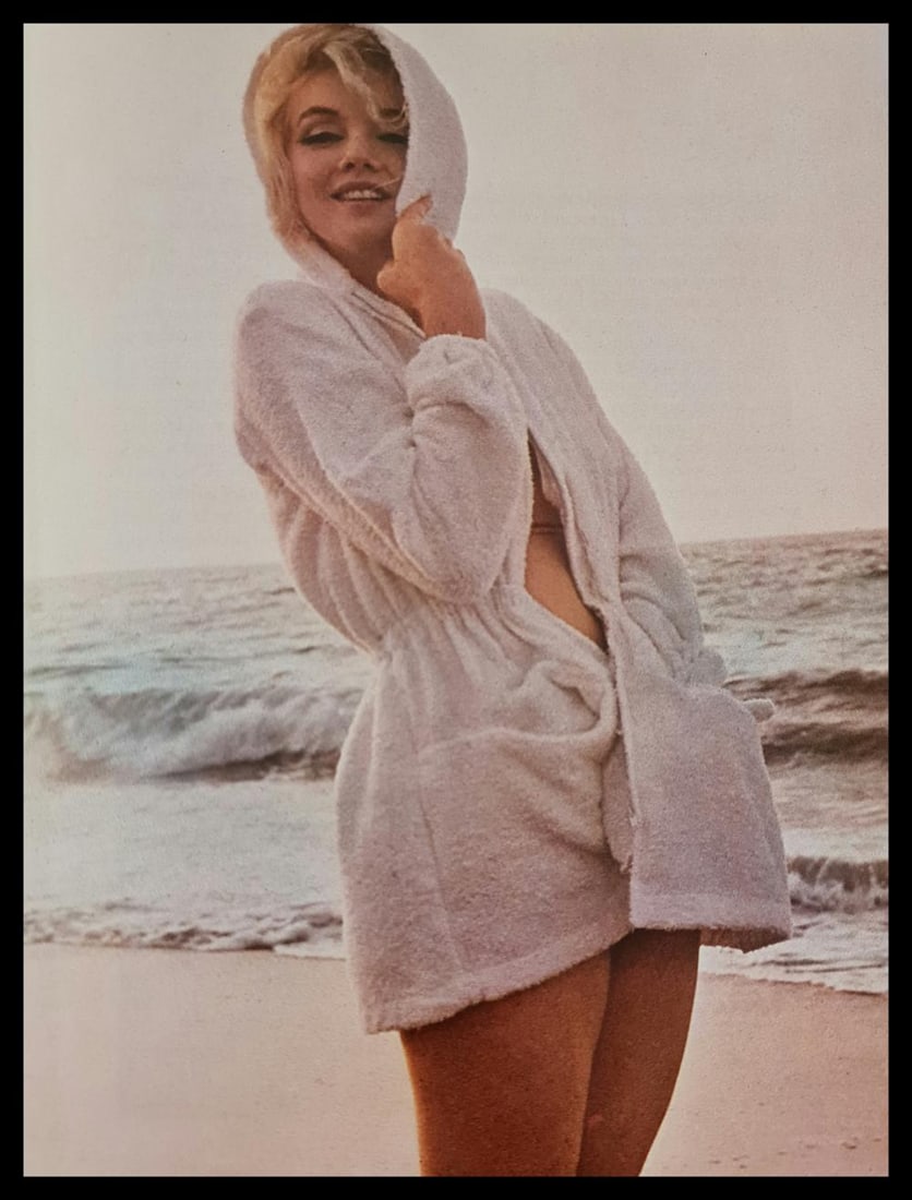 Marilyn Monroe in a robe at the beach: Photographer: George Barris Subject/Title: Marilyn Monroe in a robe at the beach Date Of Negative: Undated Type Of Print: Authentic Vintage Sheet Fed Photogravure/Heliogravure Date Of Print: 2000 Publ
