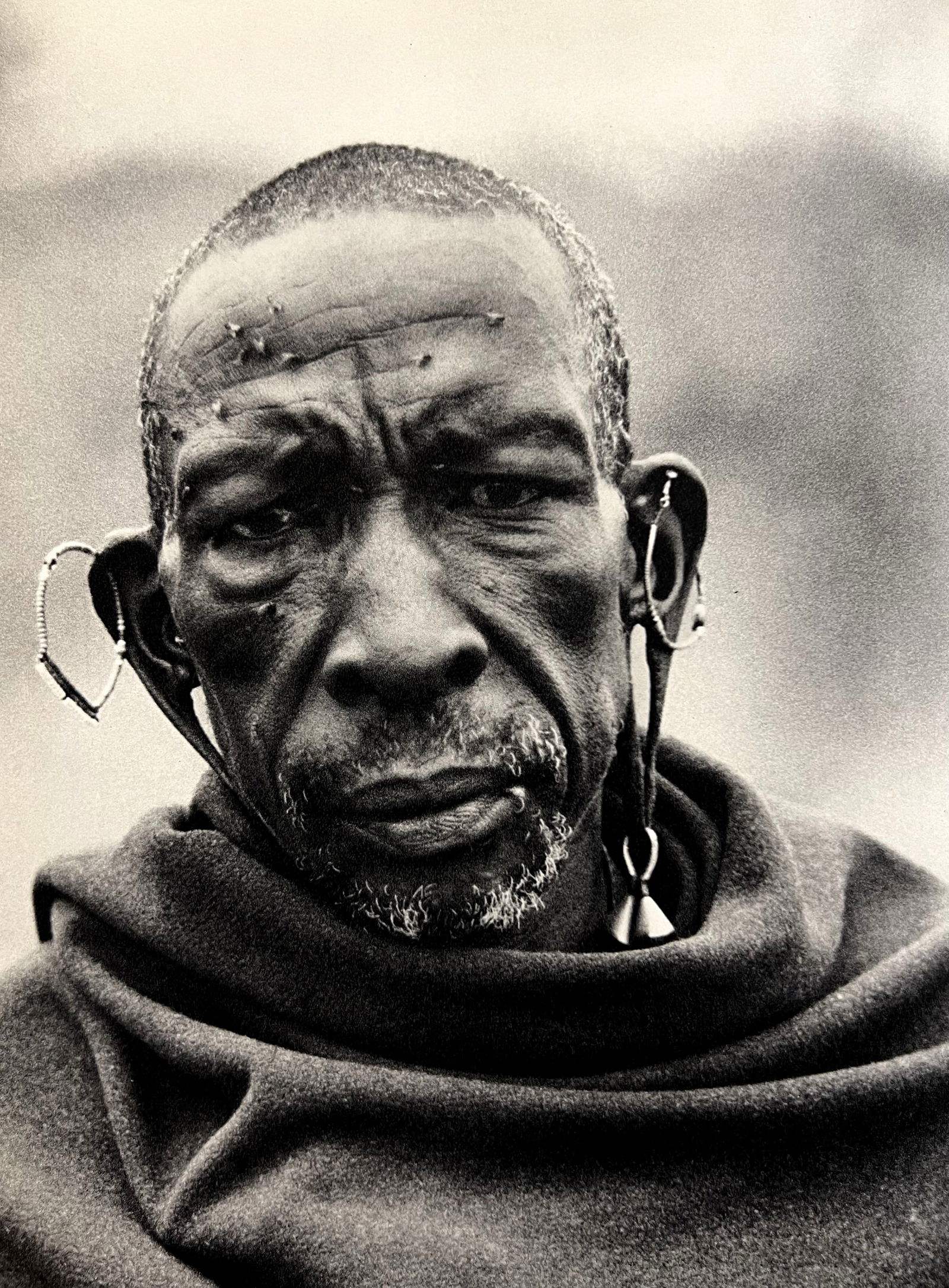 Peter Hill Beard, The Old Masai 'Mezee', With Flies And Blanket, 1960's: Photographer: Peter Hill Beard (January 22, 1938 – March 31 / April 19, 2020) was an American artist, photographer, diarist, and writer who lived and worked in New York City, Montauk and Kenya. His