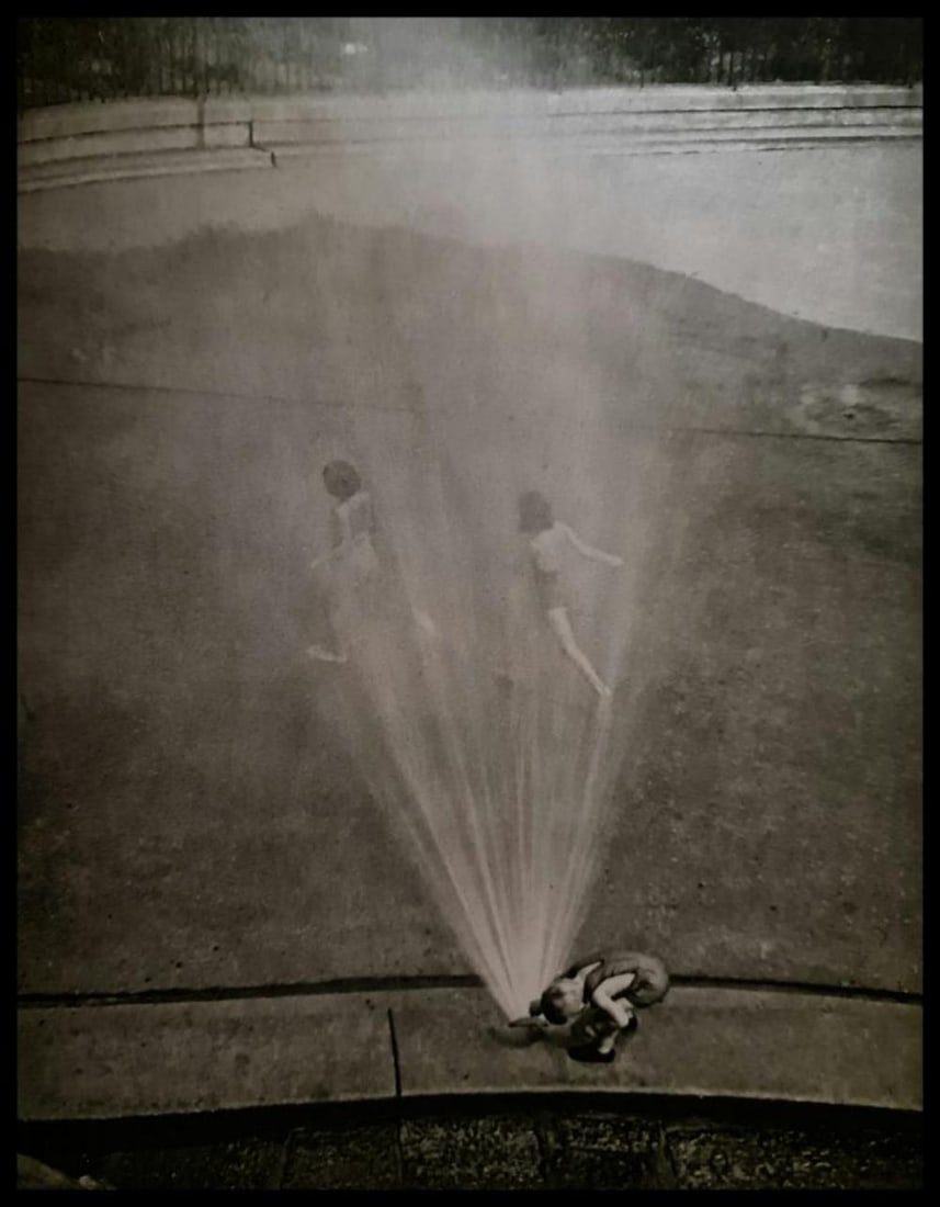 André Kertész, Boy with sprinkler, 1939: Photographer: André Kertész, born Andor Kertész, was a Hungarian-born photographer known for his groundbreaking contributions to photographic composition and the photo essay. Subject: Boy with spri
