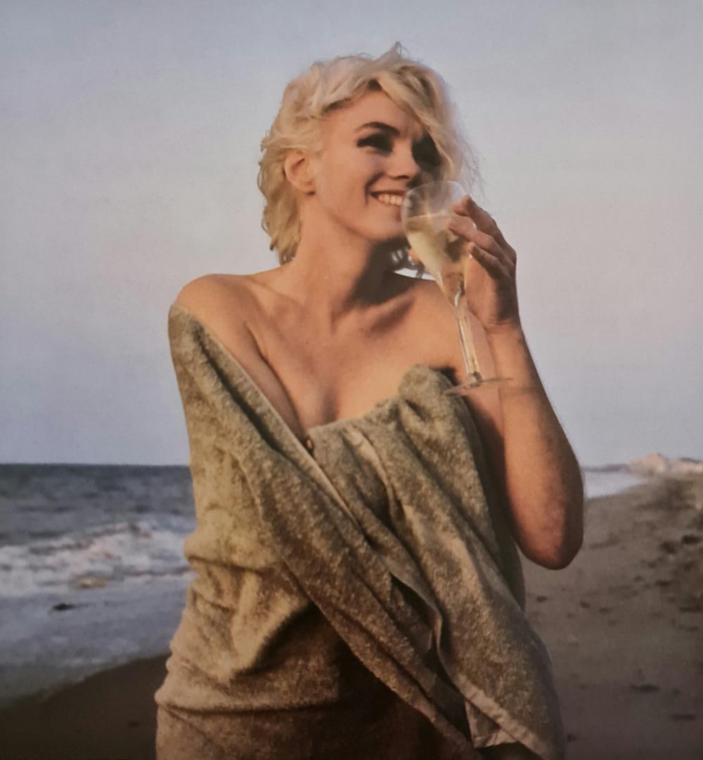 Marilyn Monroe, With a glass of wine on the beach: Photographer: George Barris Subject/Title: Marilyn Monroe, With a glass of wine on the beach Date Of Negative: Undated Type Of Print: Authentic Vintage Sheet Fed Photogravure/Heliogravure Date Of Prin