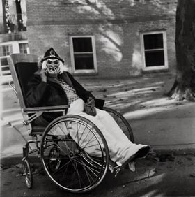 Diane Arbus, Masked woman in a wheelchair, Pa, 1970