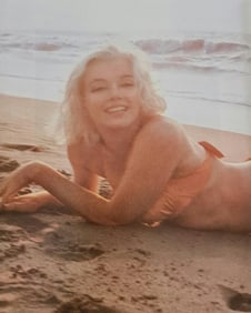 Marilyn Monroe on the beach in orange bikini