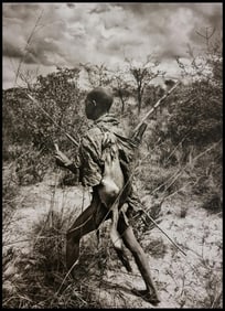 Sebastiao Salgado, A hunter carrying a native hare, Botswana, 2008