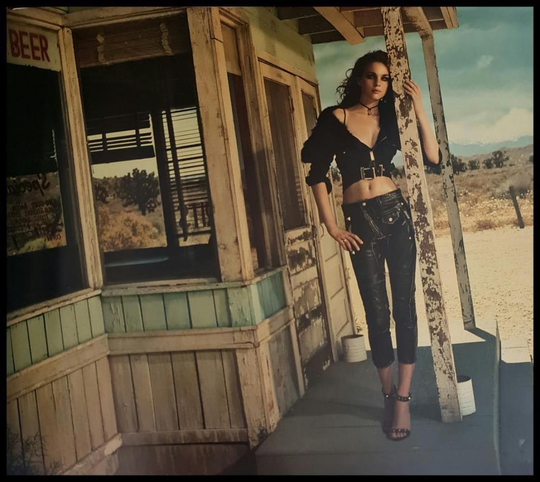 Jacques Olivar, Crossroads Cafe, Nevada, 2005: Photographer: Jacques Olivar, born in Casablanca in 1941, was an advertising photographer and movie director before embracing fashion photography. Visual seduction and cinematic sensibility are keys t