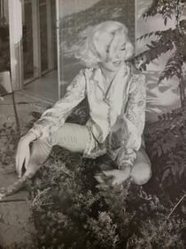 Marilyn Monroe sitting on foliage