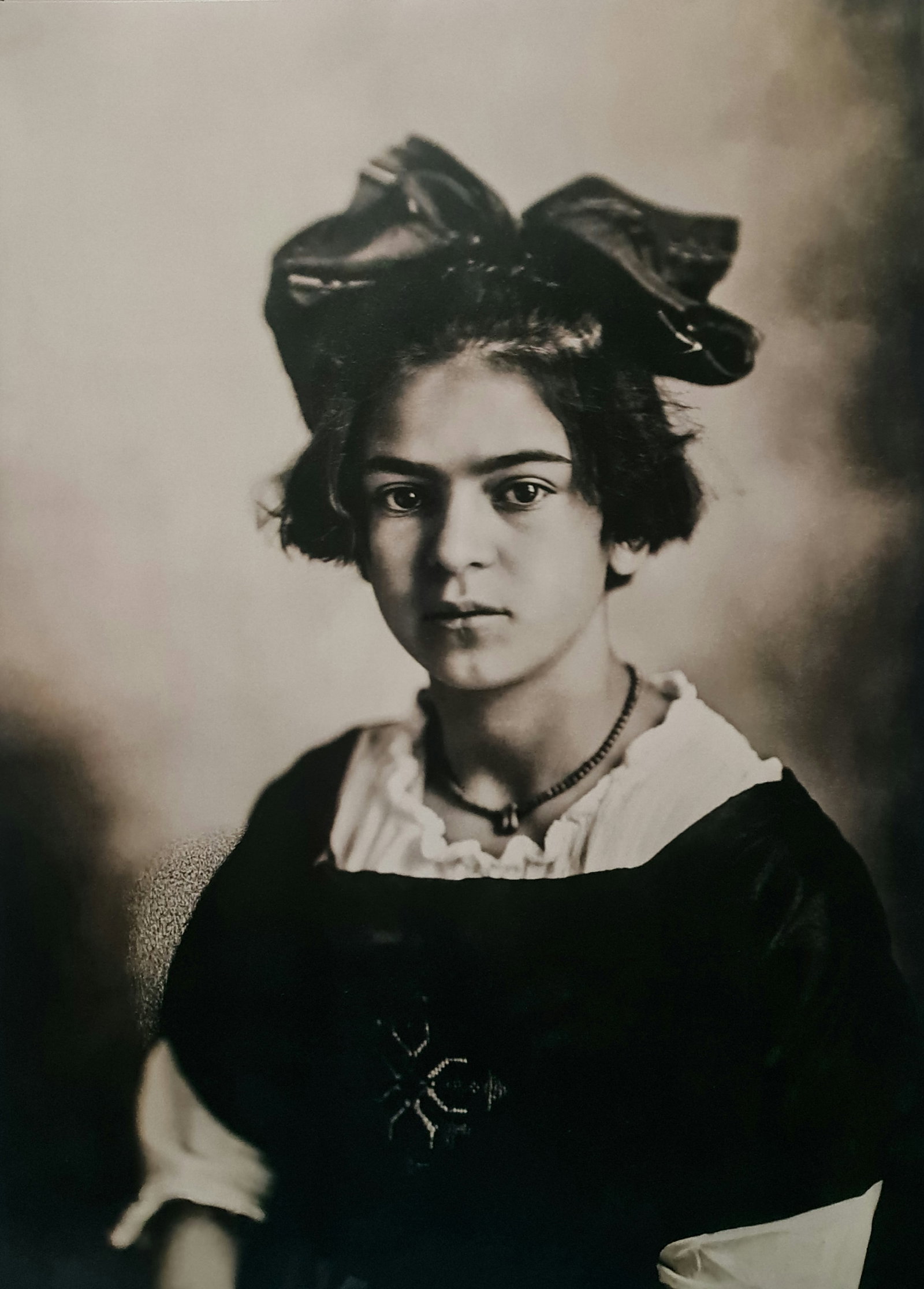 Frida Kahlo, As a young girl, 1920's: Subject: As a young girl Subject/Title- Frida Kahlo Photos Type Of Print: Authentic Vintage Sheet Fed Photogravure/Heliogravure Date Of Print: 2021 Publisher: Taschen GmbH Paper: Medium weight, clay c