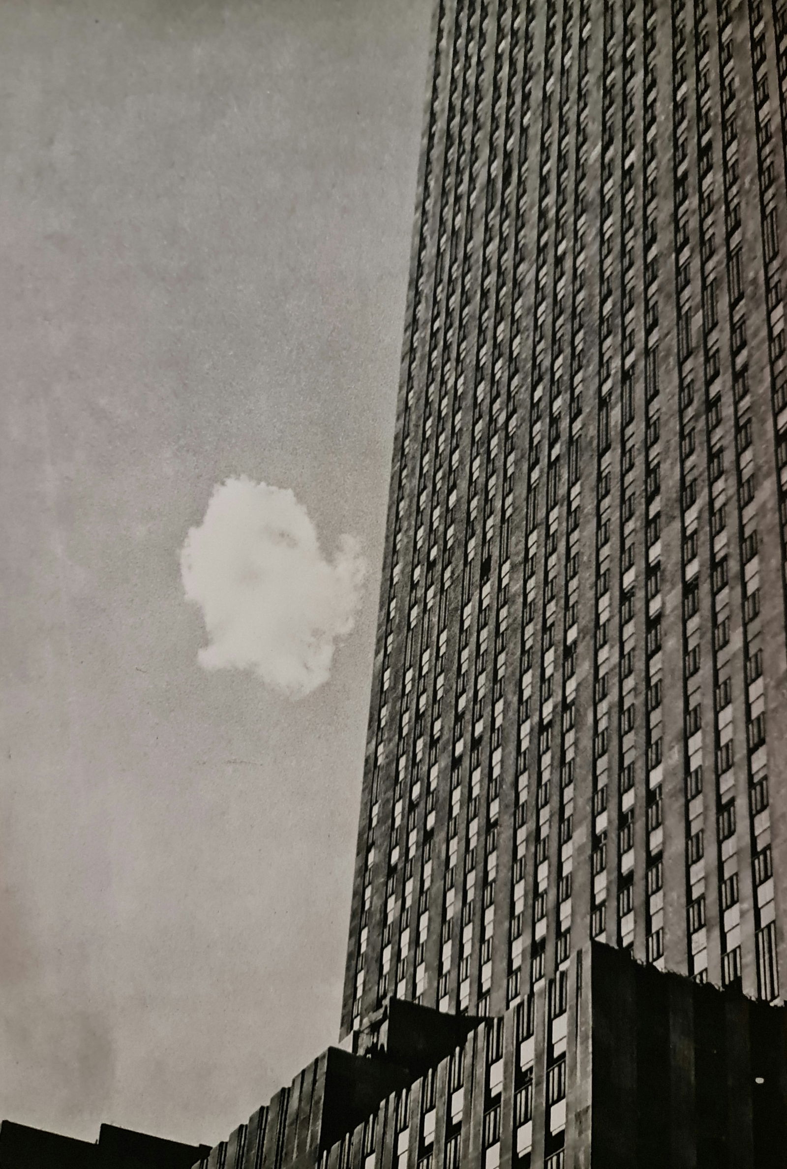 André Kertész, Cloud and Skyscraper, 1932: Photographer: André Kertész, born Andor Kertész, was a Hungarian-born photographer known for his groundbreaking contributions to photographic composition and the photo essay. Subject: Cloud and Sky