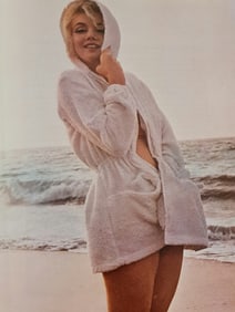 Marilyn Monroe in a robe at the beach