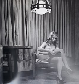 Guido Argentini, Renata sitting on a plastic chair in a very trashy hotel