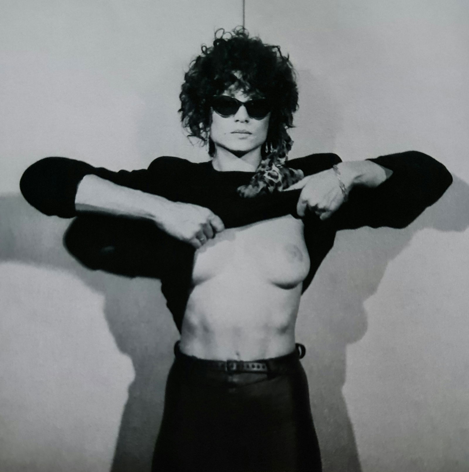 Robert Mapplethorpe, Lisa Lyon taking her shirt off: Photographer: Robert Michael Mapplethorpe (1946-1989) was an American photographer, best known for his black-and-white photographs. His work featured an array of subjects, including celebrity portrait