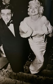 Frank Maestro, Marilyn posing for croud of photographers for premiere of East of Eden, 1955