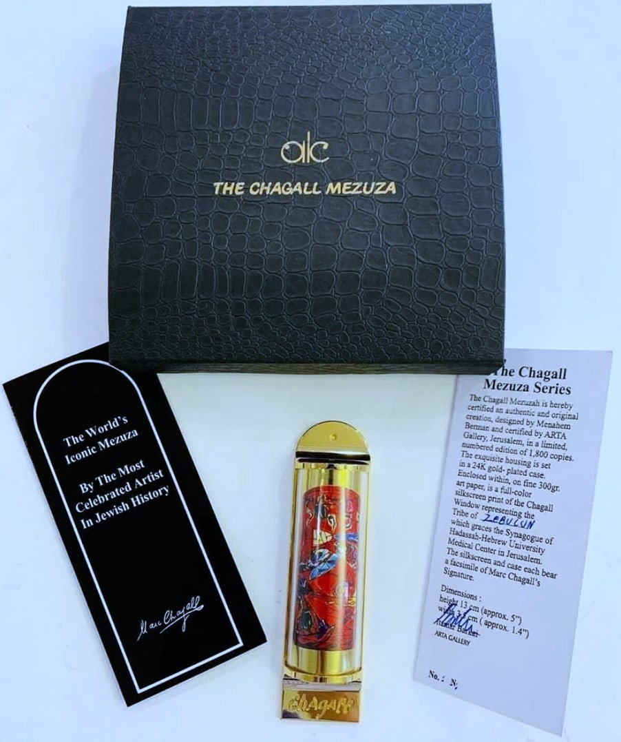 Marc Chagall, "Zebun" Limited Edition 24K Gold Plated Mezuzah: Artist: Marc Chagall Medium: Mezuzah - Exquisite glass housing is set in a 24K gold plated bronze with full color silkscreen Title: "ZEBUN" Size: 5" x 1.5" Weight: 7 oz. Limited Edition: Edition of 30