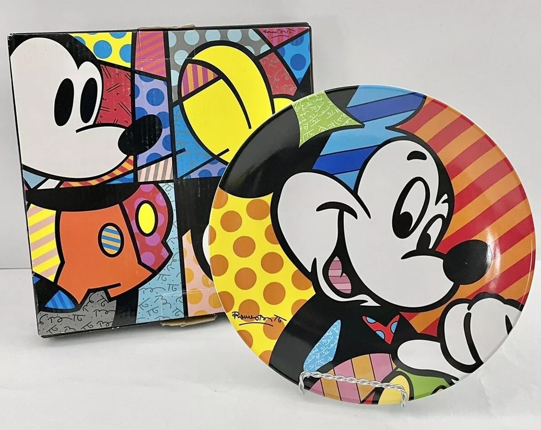 Romero Britto, Disney's Mickey Mouse Plate w/ Box, 2011: Artist- Romero Britto Plate is in excellent condition, with no chips, cracks or other damage. Measures approx. 8 3/8” in diameter. Includes original box. Display stand is not included.