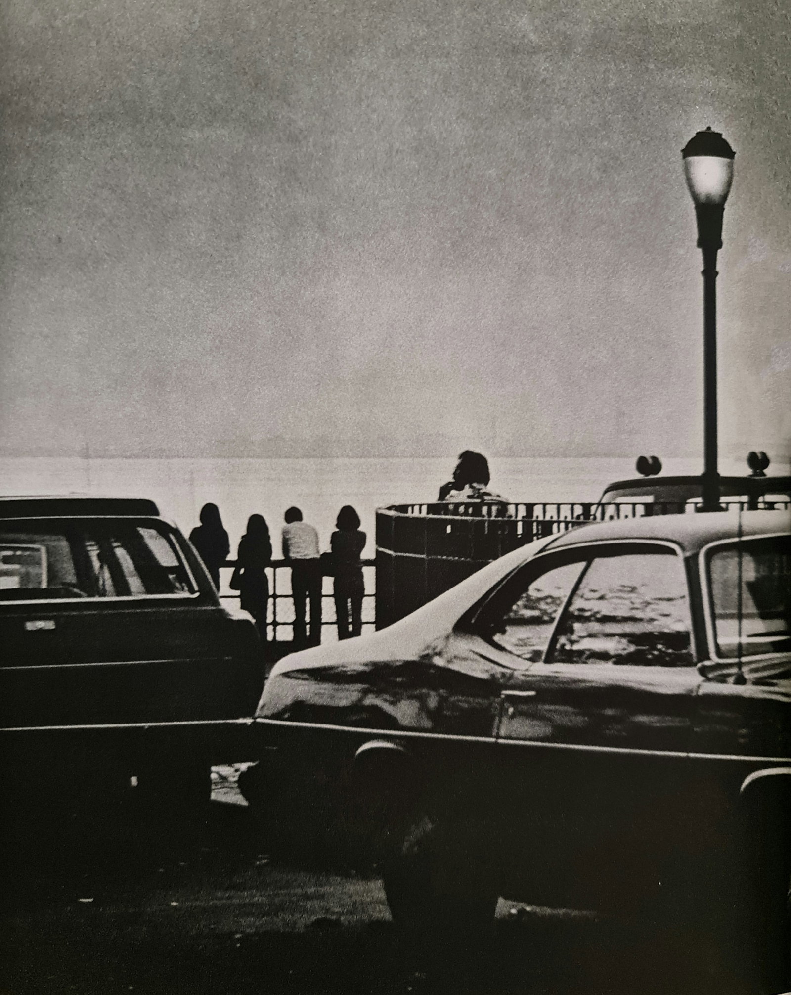 Andre Kertesz, Group looking at the water, New York, 1975: Photographer: Andre Kertesz born Andor Kert?sz, was a Hungarian-born photographer known for his groundbreaking contributions to photographic composition and the photo essay. Subject: Group looking at 