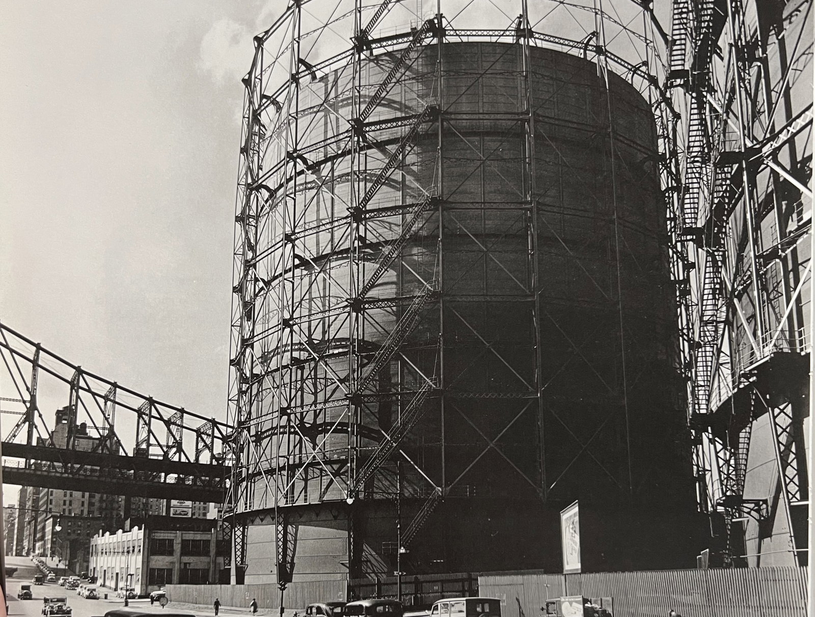 Berenice Abbott, Gas Tank And Queensboro Bridge, East 62nd Street And York Avenue, 1930s: Photographer: Berenice Alice Abbott was an American photographer best known for her portraits of between-the-wars 20th century cultural figures, New York City photographs of architecture and urban des