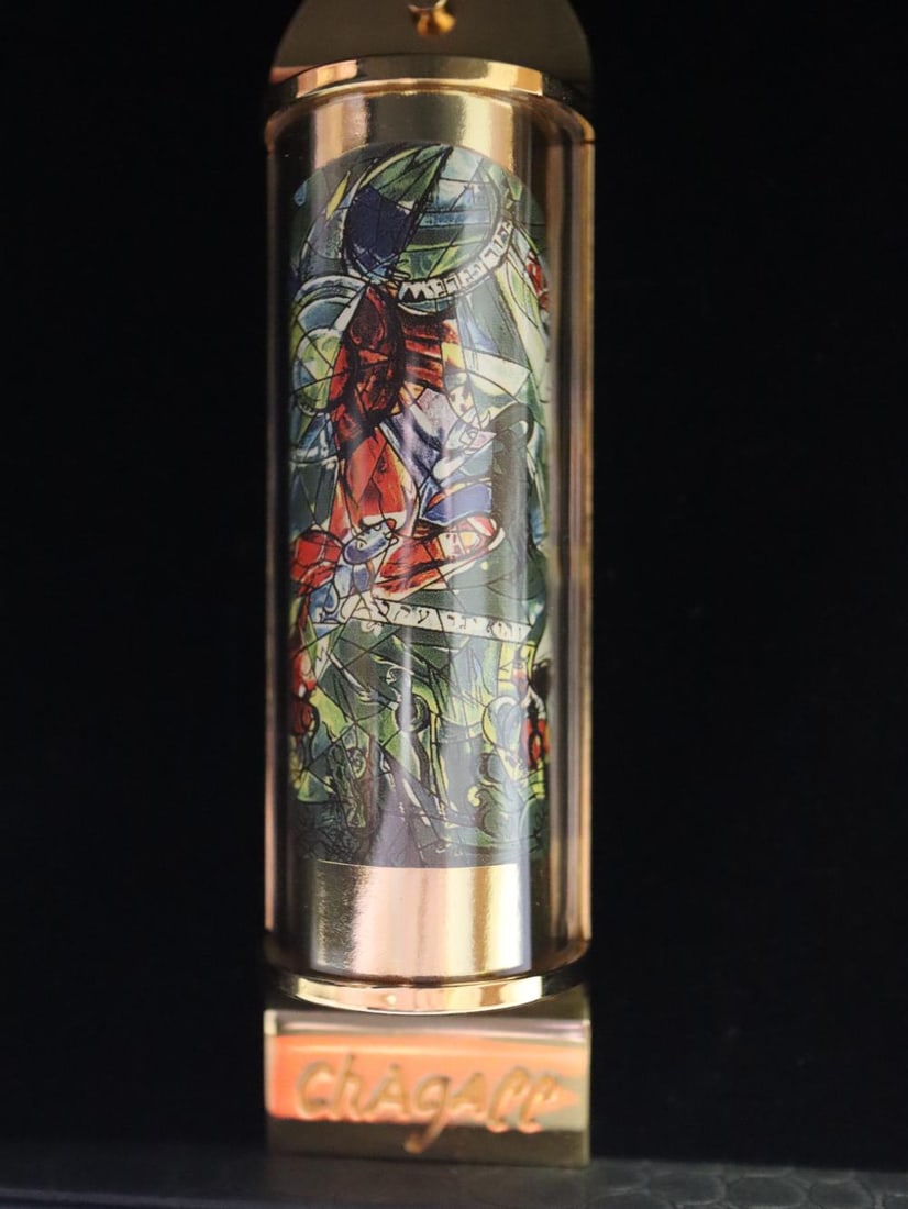 Marc Chagall, 'Gad' Silk Screen in 24K Gold Plated Limited Edition Mezuzah: Artist: Marc Chagall Medium: Mezuzah - Exquisite glass housing is set in a 24K gold plated bronze with full color Silk Screen Title: "GAD" Size: 5" x 1.5" Weight: 7 oz. Limited Edition: Edition of 300