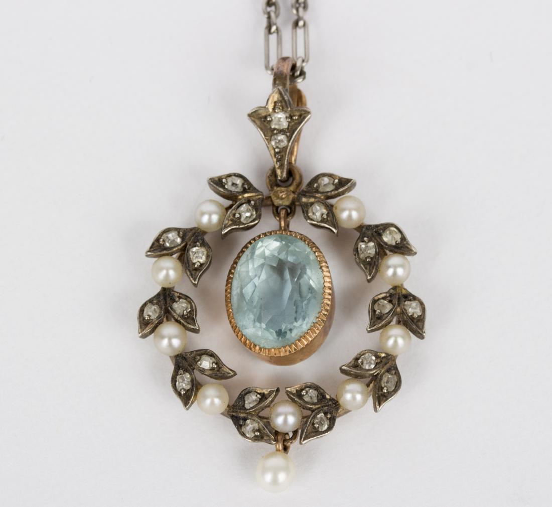 An Edwardian aquamarine pendant in a diamond and pearl: An Edwardian aquamarine pendant in a diamond and pearl wreath surround, to an unmarked fine link neck chain, the aquamarine 9.5mm x 7.5mm x 6mm/Provenance: Beverston Castle
