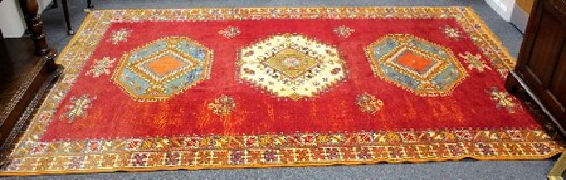 A 20th Century Moroccan red ground carpet, 305cm x (1 of 3)