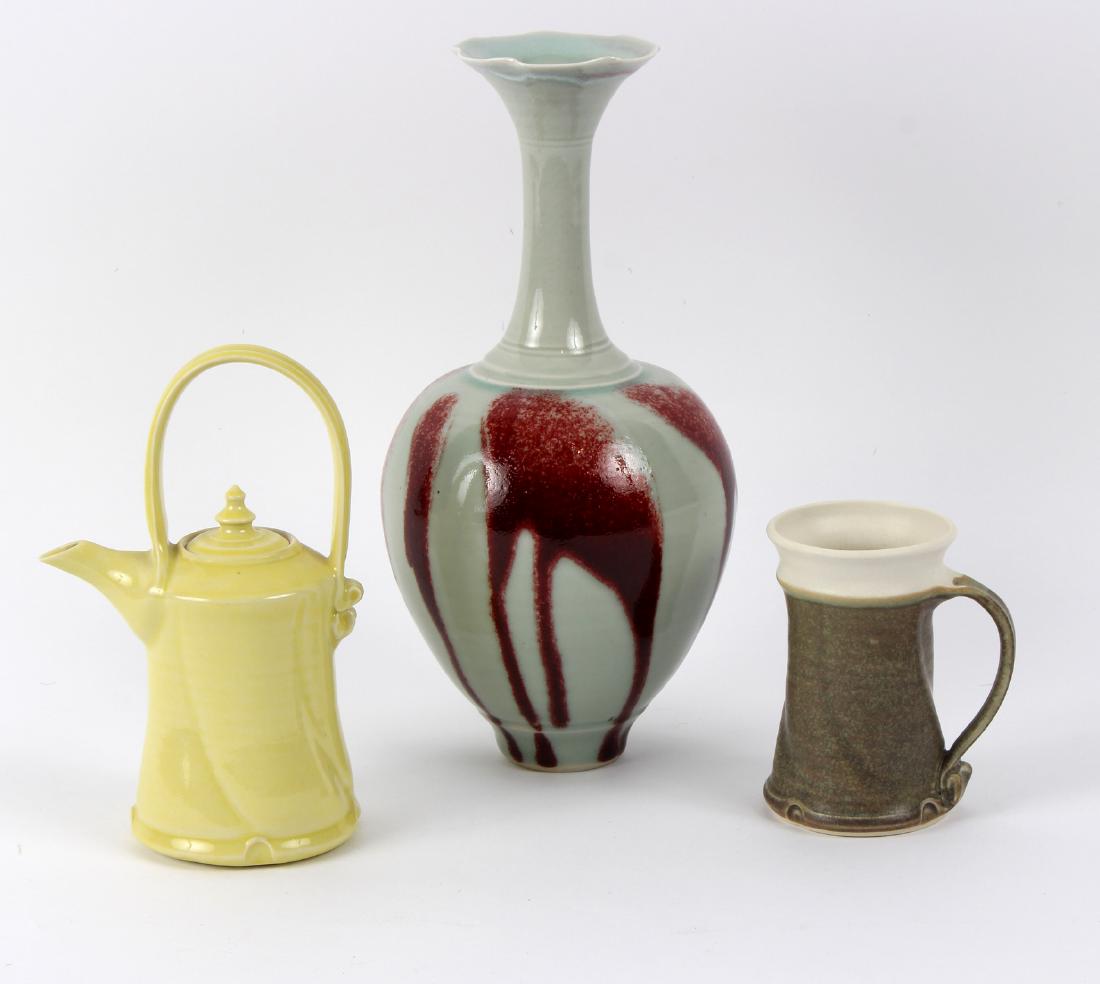 Bridget Drakeford (British, born 1946), a celadon: Bridget Drakeford (British, born 1946), a celadon glazed vase with red drip body, of baluster form with tall neck and flared rim, 28.5cm high, signed and impressed to seal mark to base and a yellow te