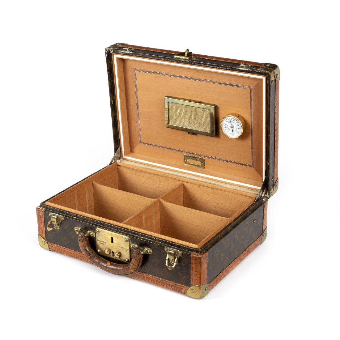 Louis Vuitton, a cigar humidor of briefcase form, the: Louis Vuitton, a cigar humidor of briefcase form, the exterior in patterned signature leather with brass mounts, the clasps stamped with LV monogram, the lockplate further stamped with London and Pari