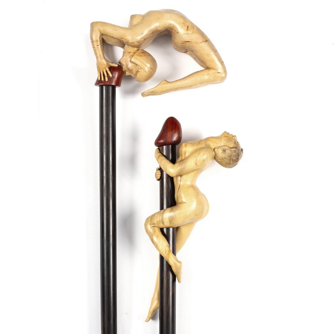 Ian Norbury (British, born 1948), two carved walking: Ian Norbury (British, born 1948), two carved walking sticks of erotic design, in lime and other woods/Provenance: Eastington Hall, Worcestershire
