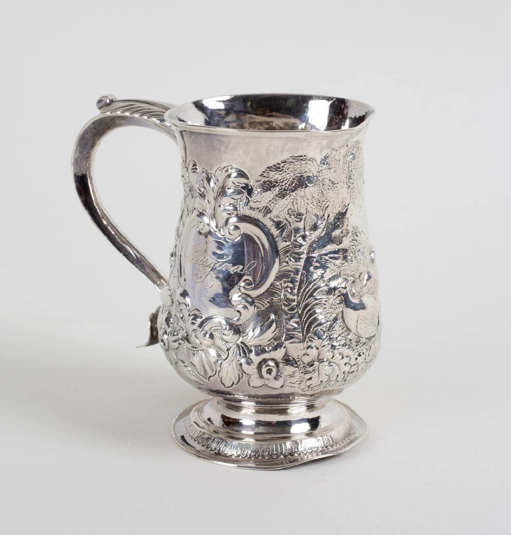A George III silver tankard, James Smith, London 1771,: A George III silver tankard, James Smith, London 1771, later embossed a woodland scene, 12cm high, approximately 217gm